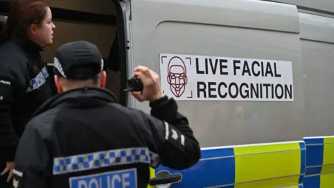 Police officers man a live facial recognition van on the High Street in December 2024 in Southend, England.