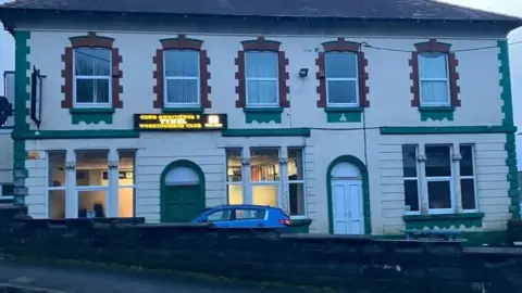 A old cream and green building