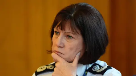 PA Media Chief Constable Jo Farrell with her hands on her chin and looking concerned