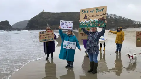 Protestors at Portreath beach in Cornwall