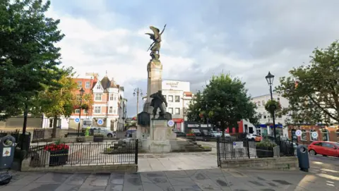 Google The war memorial cenotaph pictured in Londonderry city centre. 
A large plinth with a person with wings and their arms outstretched is at the top, while a statue of a soldier is visible nearer the front lower section of the display. 