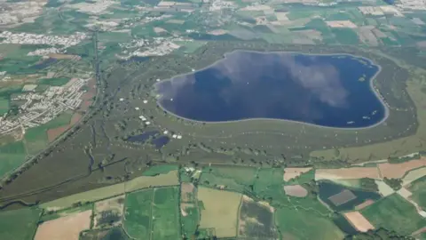 Thames Water Patchwork of green fields around a puddle-shaped reservoir