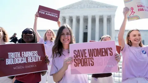 Women hold placards as they celebrate the US Supreme Court's ruling