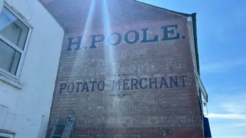 Potato merchant ghost sign