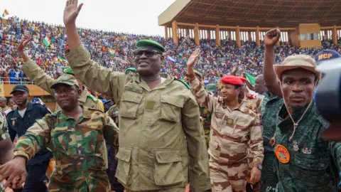 Getty Images Mohamed Toumba, one of the leading figures of the National Council for the Protection of the Fatherland, attends the demonstration of coup supporters and greets them at a stadium in the capital city of Niger, Niamey on August 6, 2023