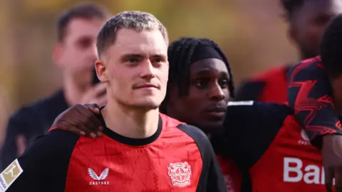 Florian Wirtz looks at the crowd after a game for Bayer Leverkusen