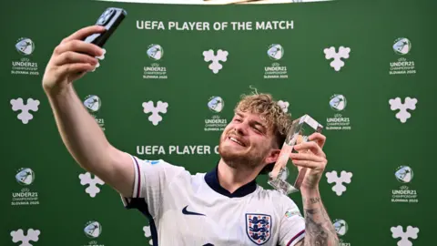 Harvey Elliott celebrates with the man of the match trophy.