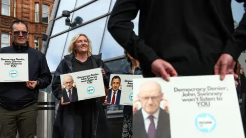 PA Media Reform campaigners outside the anti far-right summit in Glasgow.