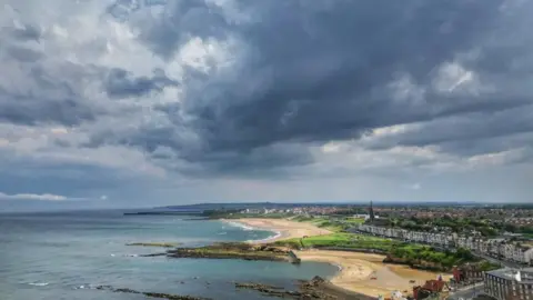 PA Media Storm clouds gathering over the coast at Tynemouth