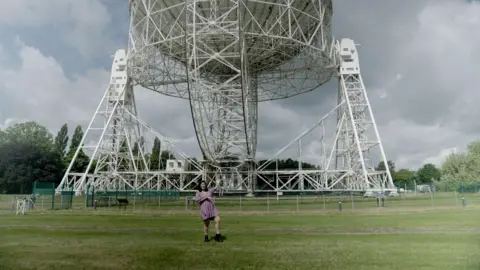 George Dransfield standing in front of the Lovell telescope.
