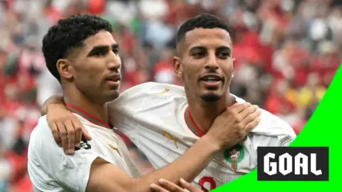 Achraf Hakimi & Azzedine Ounahi smiles to the crowd while hugging after scoring for Morocco in the 2026 World Cup.