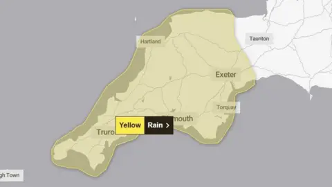 Met Office Map graphic showing Devon and Cornwall covered by a yellow weather warning for rain on the Met Office website.