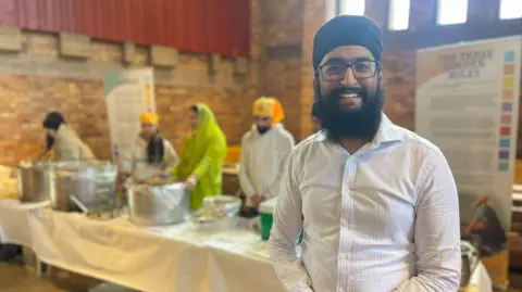 Gurjivan Sohal Gurjivan Sohal stood in front of serving dishes