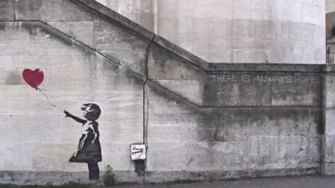 Banksy Mural of Girl With Balloon stencil on wall