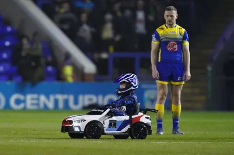 PA Media Whizzy Rascal and a Warrington Wolves player