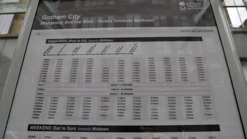 PA Media A bus timetable prop for a Batman film, listing buses for Gotham City 