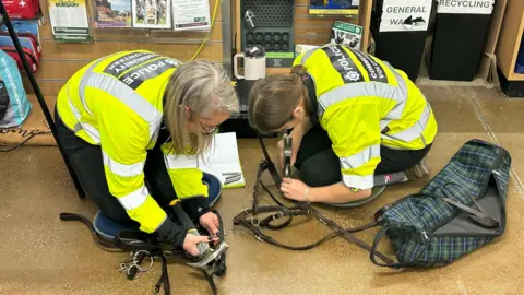Police officers tack marking equestrian equipment including a bridle.