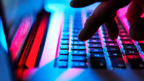 Close up of person's hand on keyboard