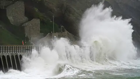 Gareth Fuller/PA Wire Waves crash over the promenade during rain and strong winds in Folkestone, Kent. The Met Office has issued yellow weather warnings for wind over the coming days.