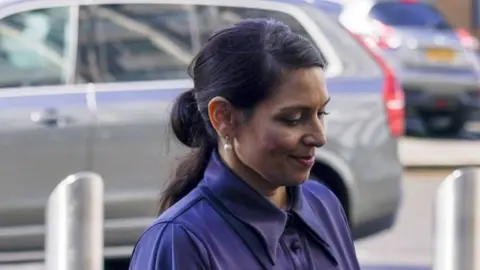 PA Media Priti Patel arriving for the meeting