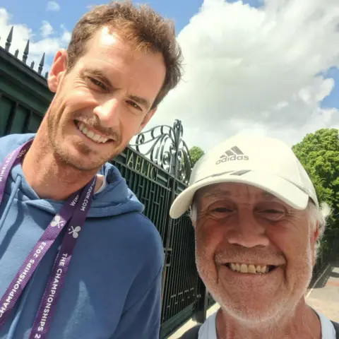 Supplied Geoff is taking a selfie with Andy Murary at Wimbledon 