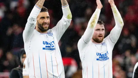 Connor Goldson and John Souttar applaud the Rangers fans at the Estadio da Luz