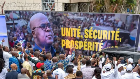 AFP The President Felix Tshisekedi (C) delivers his speech in front of supporters after the announcement of the election results at QG Fatshi 20, the headquarters of his electoral campaign, in Gombe, Kinshasa, on December 31, 2023