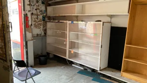 Empty shelves in the former Roll On Blank Tapes