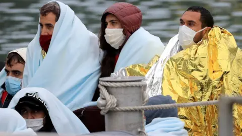 PA Media Migrants are brought into Dover, Kent, on a boat