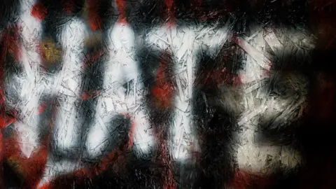 Graifitti shows the word 'hate' written in white against a black and red backdrop