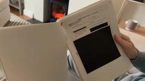 Close up image of a page within a pack of documents which has been heavily redacted. 