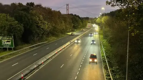 Paul Murphy/BBC News Cars travelling down both carriageways on the A63 in the dark.