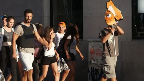 AFP Terrified children helped to safety