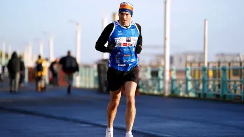 PA Media Kevin Sinfield running an ultra-marathon in Brighton