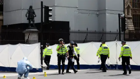 Getty Images Forensics officers could be seen at the scene of the crash