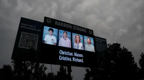 Reuters Photos of the victims of the Apalachee High School shooting are displayed on a screen during a vigil at Jug Tavern Park in Winder, Georgia, U.S. September 6, 2024