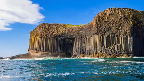Staffa's famous geology and Fingal's Cave. The striking hexagonal basalt rock columns were formed by ancient volcanic eruptions.