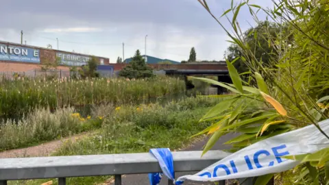 BBC The canal with police tape in the foreground