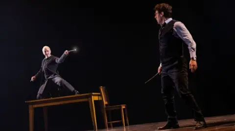 Tom Felton on the left as Draco Malfoy and John Skelley as Harry Potter.