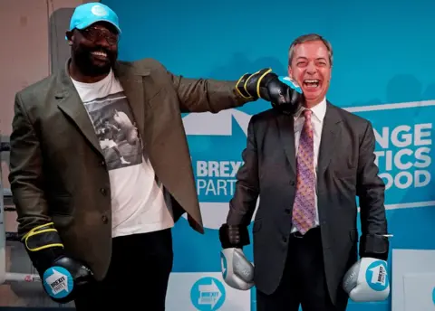 Niklas Hallen / AFP Nigel Farage poses with British boxer Dereck Chisora