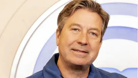 BBC A picture of John Torode in a blue shirt