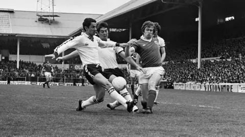 Tottenham Hotspur Football Club's Osvaldo Ardiles (Ossie Ardiles), left, and Paul Miller, centre, in action against Everton FC's Peter Eastoe during a match at White Hart Lane stadium, London, May 5th 1979