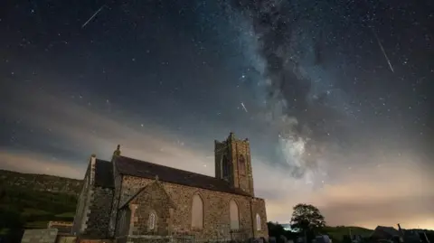 Patryk Sadowski Shooting stars over a church in Limavady