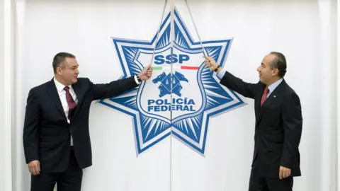 Getty Images Mexican President Felipe Calderon (R) and the Secretary of the Mexican Federal Police Genaro Garcia Luna (L) prepare to inaugurate the Mexican Federal Police new Intelligence Center, in Mexico City, on November 24, 2009