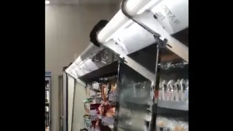 @Ginkai19990324 A rate peers over a food cabinet at a Family Mart store