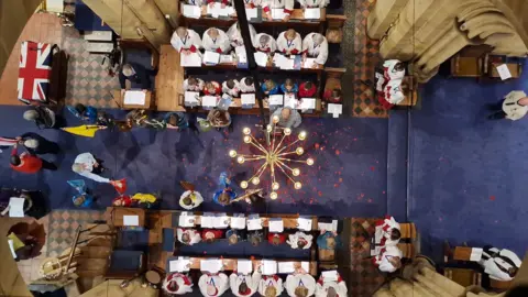 View from above of St Paul's church, Rusthall, Kent, with poppies scattered during mass at BBC 2023