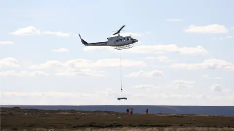 Arqiva A helicopter delivering concrete blocks at the transmitter site