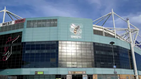 PA/Jacob King The exterior of the Ricoh Arena, with the Wasps logo in the middle of the picture.
