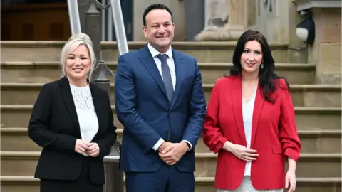 PA Media First Minister Michelle O'Neill, Taoiseach Leo Varadkar and Deputy First Minister Emma Little-Pengelly at Stormont Castle