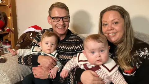 BBC Mum, dad and the kids on the sofa in Christmas jumpers